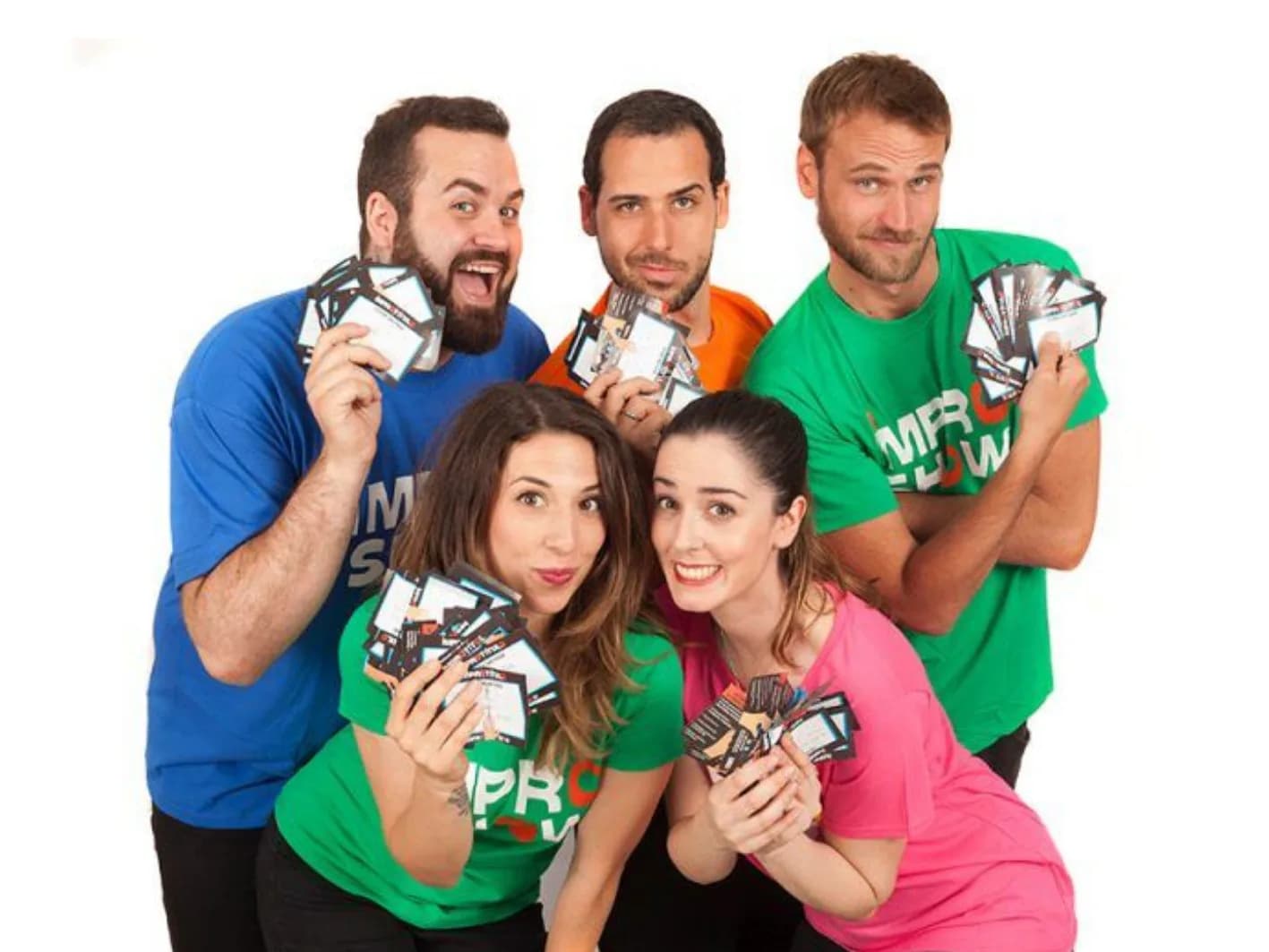 Reparto de Impro Show con camisetas verde, naranja, rosa y azul mostrando entradas en abanico, espectáculo improvisado